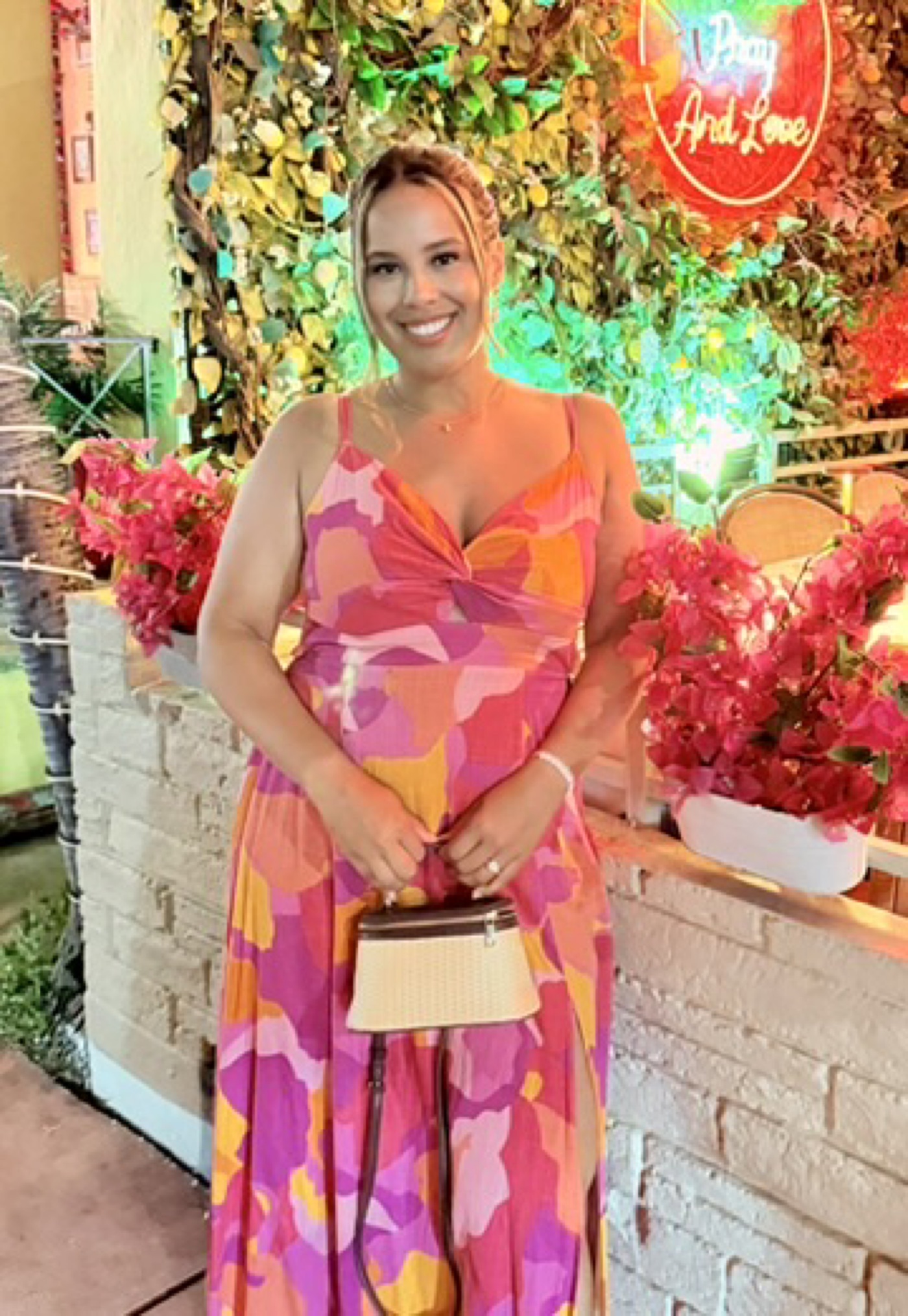Karen Abreu smiling in a colorful pink dress
